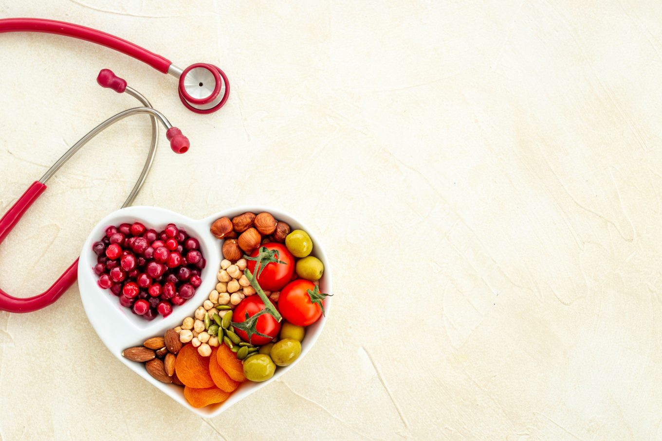 Book Combinations of Tests 3 Heart-shaped bowls of heart-healthy foods lie next to a red stethoscope on a cream surface.